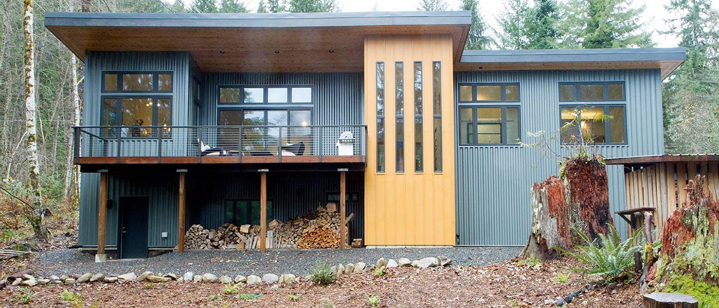 Contemporary chalet with a golden-yellow accent tower built by Kestrel Homes
