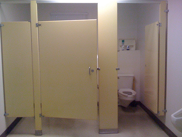 Restroom partitions at Anvil Corp before the remodel